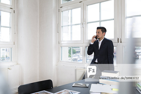 Businessman making phone call in his office