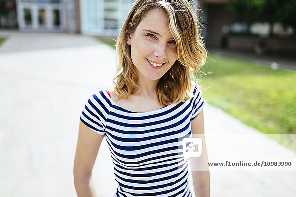 Portrait of relaxed young woman wearing striped t-shirt