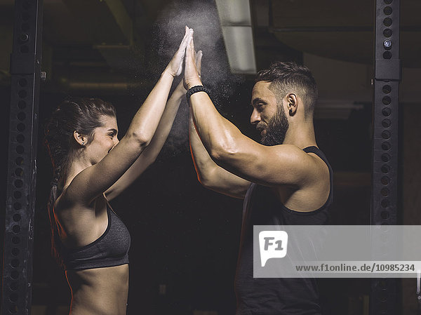 Fitness  couple in gym  high five
