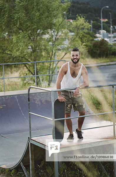 Smiling skateboarder in a skatepark