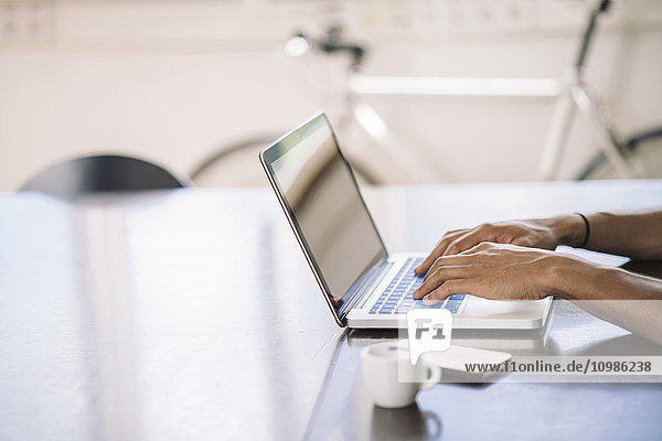 Young man working on laptop in office
