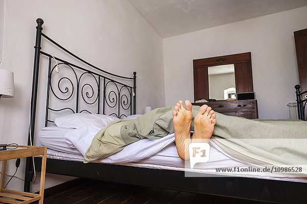 Woman lying in bed  feet