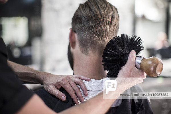 Barber brushing of customer