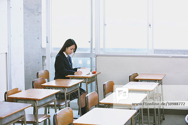 Japanese high-school student in empty classroom