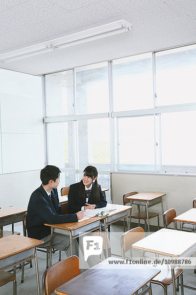 Japanese high-school students in empty classroom