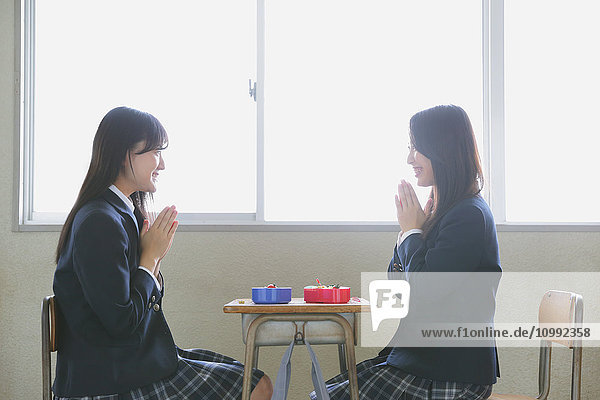 Japanese high-school students having bento in classroom