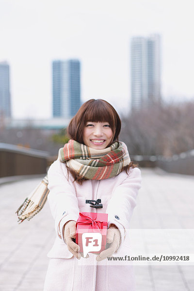 Attractive Japanese woman with gift on a Winter day