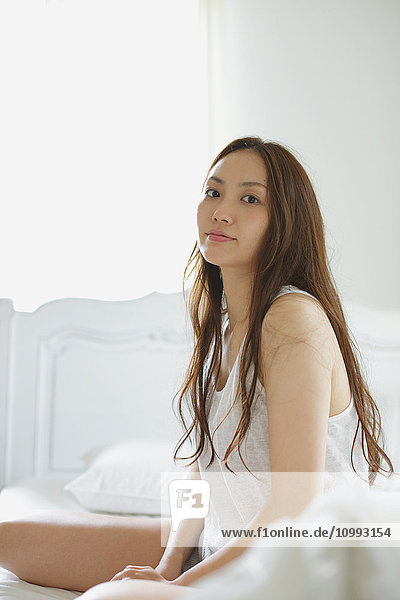 Young attractive Japanese woman in bed