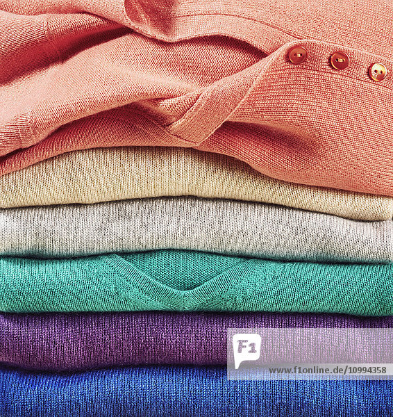 Detail of stack of multicolored wool pullovers