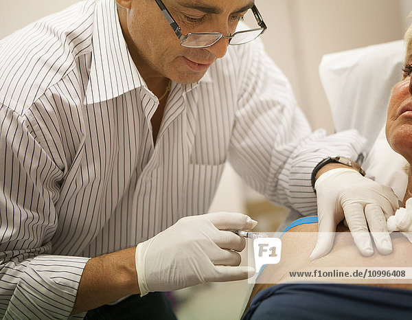 Reportage on a GP who uses mesotherapy in Geneva  Switzerland. Mesotherapy is a medical treatment which consists of administering medicine through micro-injections in the skin. Here the doctor injects a patient with hyaluronic acid.