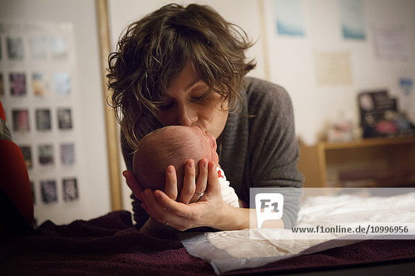 Reportage on a haptonomy professional. Postnatal haptonomy session with a couple. After the birth  the professional offers sessions with the newborn baby.