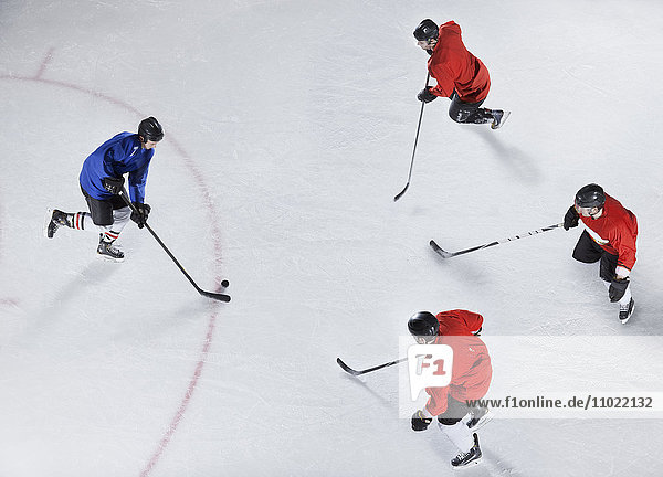 Hockey defenders guarding opponent with puck on ice