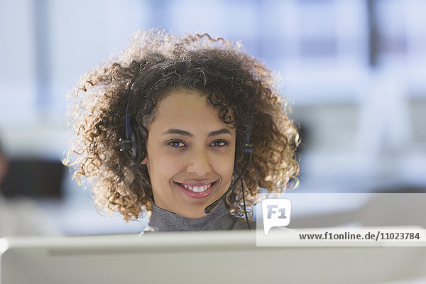 Portrait confident businesswoman with headset in office