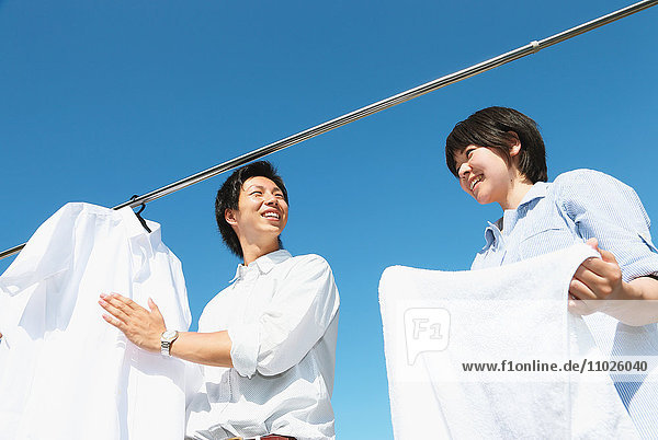 Young Japanese couple doing laundry