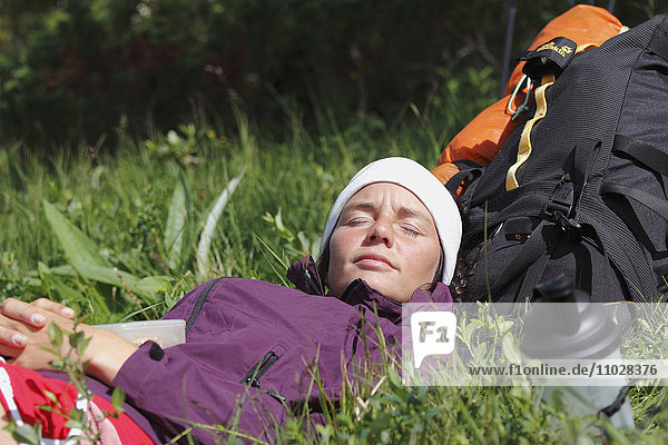 Young hiker resting on grass