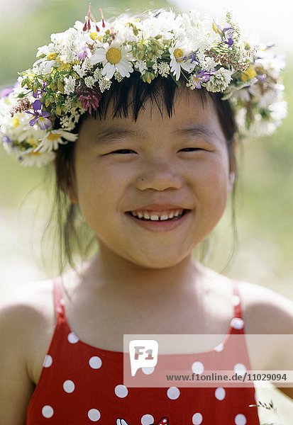 Girl with flower wreath on her head.