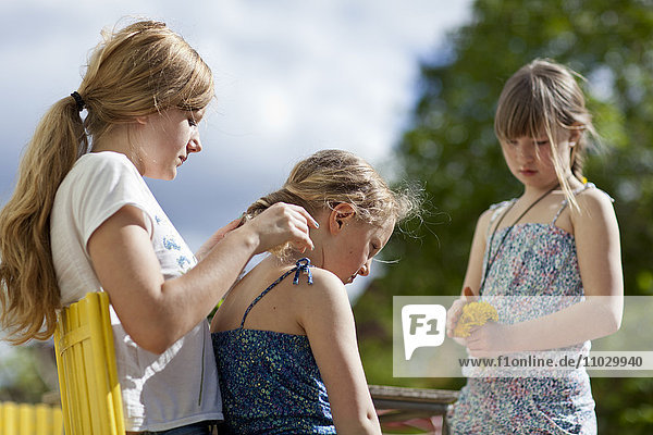 Girl braiding friends hair