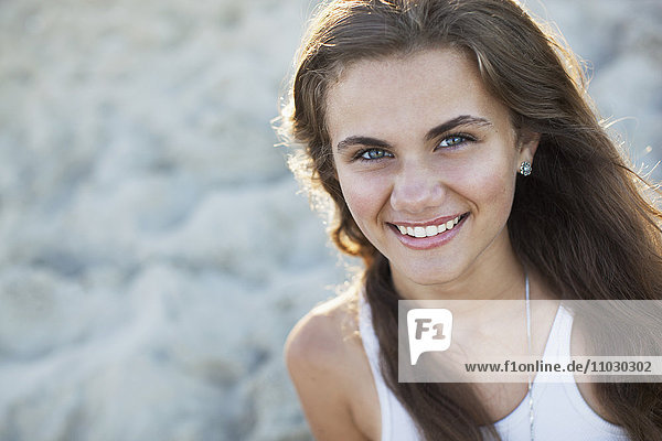Teenage girl smiling on beach