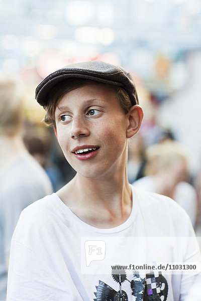 Teenage boy wearing cap looking away