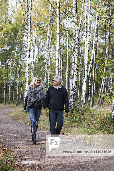 Senior couple walking through forest  Delsjon  Gothenburg  Sweden