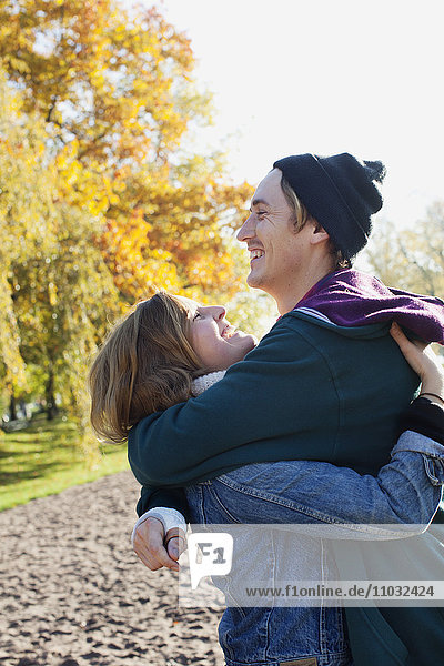 Young couple embracing in park