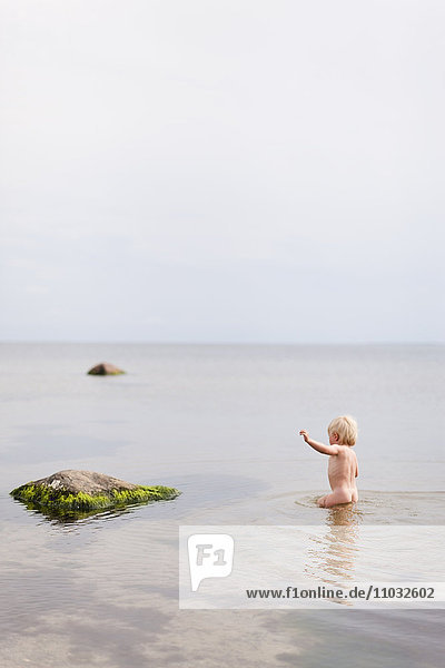 Baby playing in sea