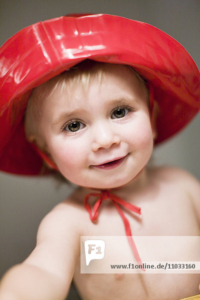 Studio portrait of boy wearing red hat