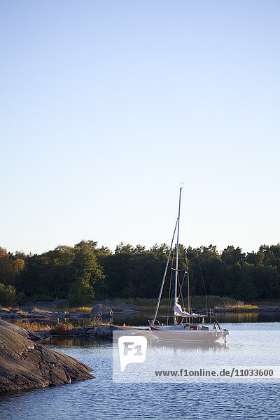 Sailing boat moored on sea