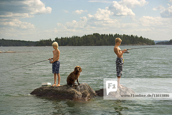 Two boys fishing in a lake.