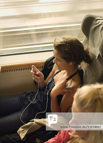 Two teenage girls on a train.