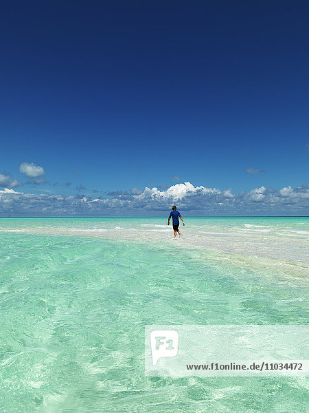 Boy wading in tropical sea