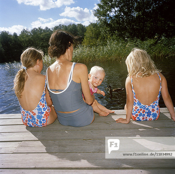 Mother and daughters swimming  Sweden.