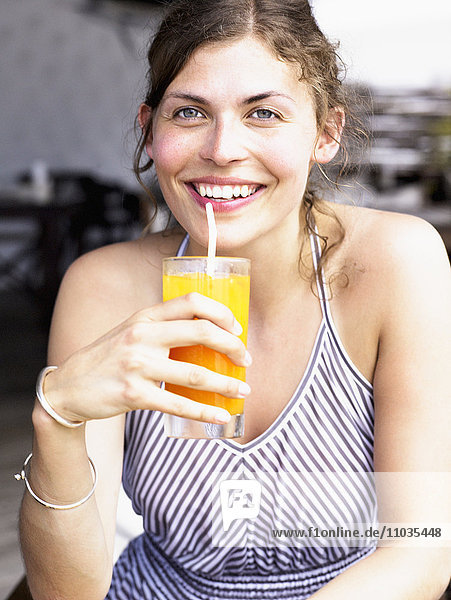 A woman drinking juice.
