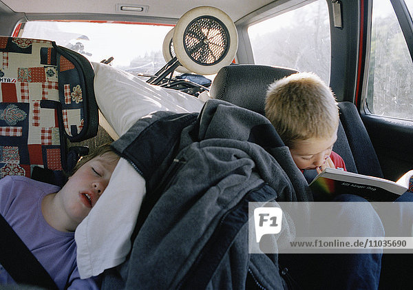 Two children in the backseat of a car  Sweden.