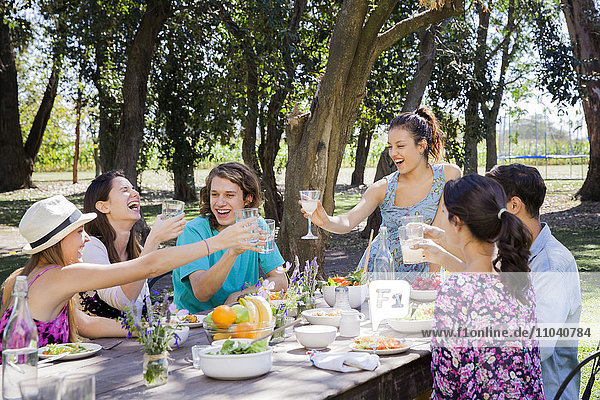 Friends having carefree meal outdoors together