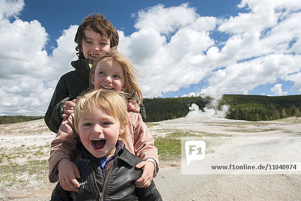 Young siblings posing for portrait at Yellowstone National Park  Wyoming  USA