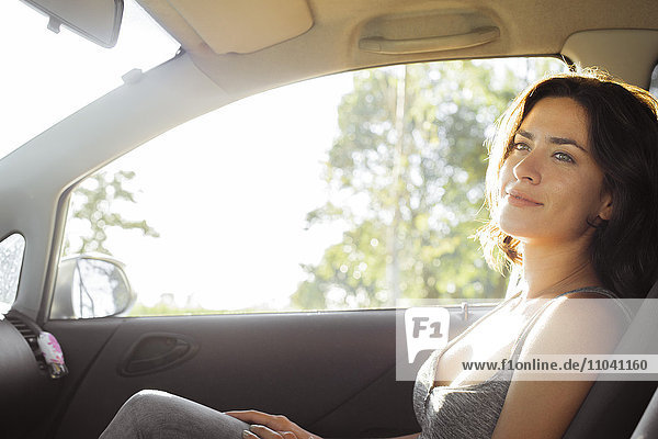 Woman passenger in car enjoying tranquility of travel