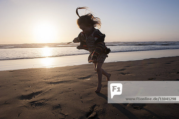 Little girl running on beach