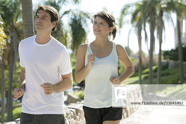 Couple jogging together in park