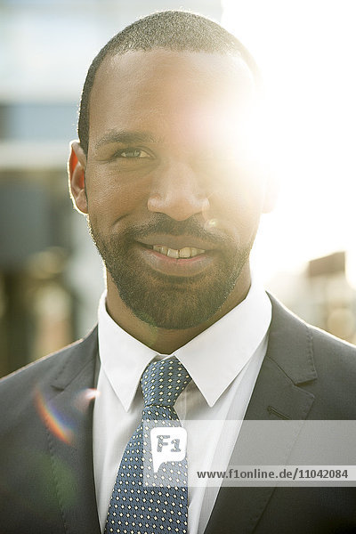 Businessman backlit by sun  portrait