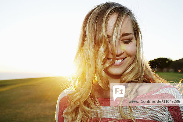 Caucasian woman smiling in field