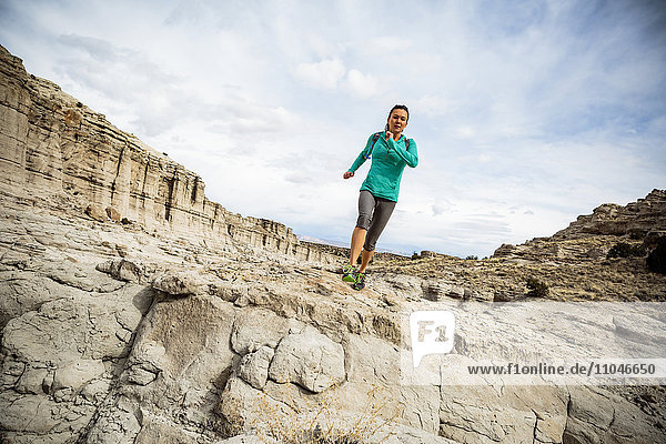 Woman running in canyon