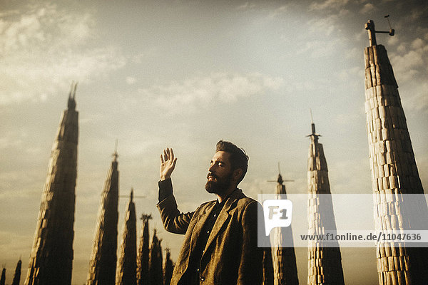 Caucasian man praying near spires