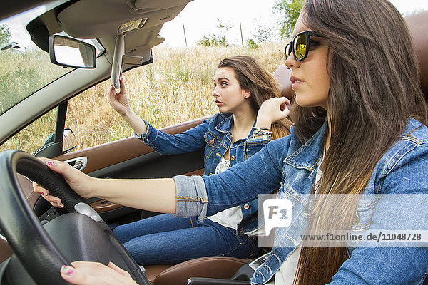 Women driving in convertible