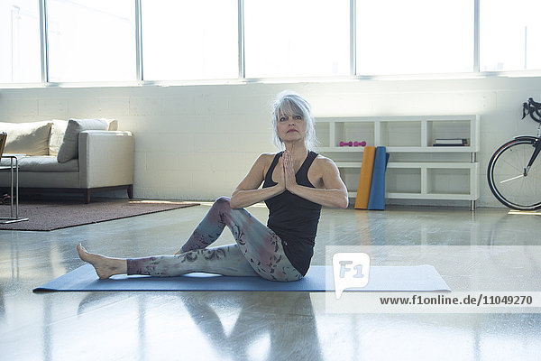 Woman doing yoga with hands clasped