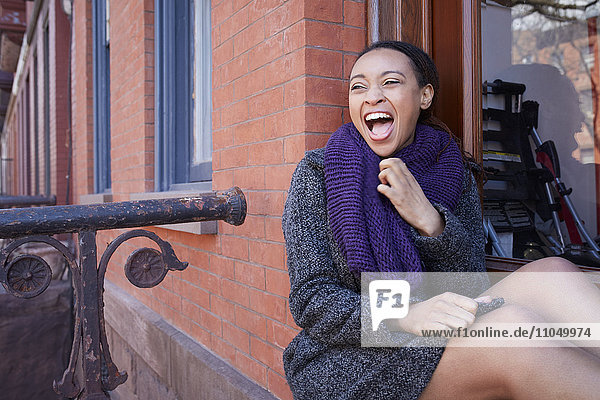 African American woman laughing in window