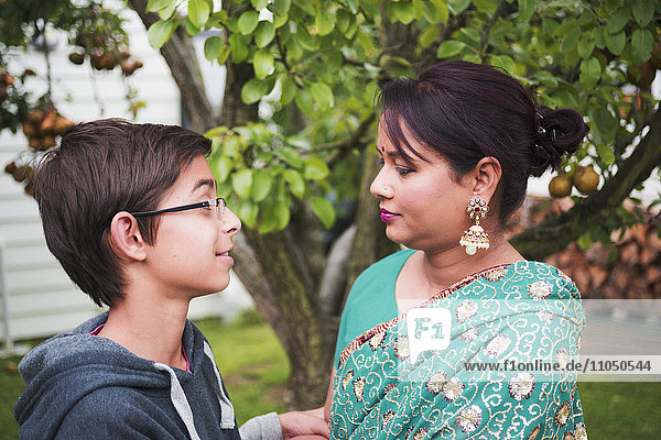 Mother and son talking in garden