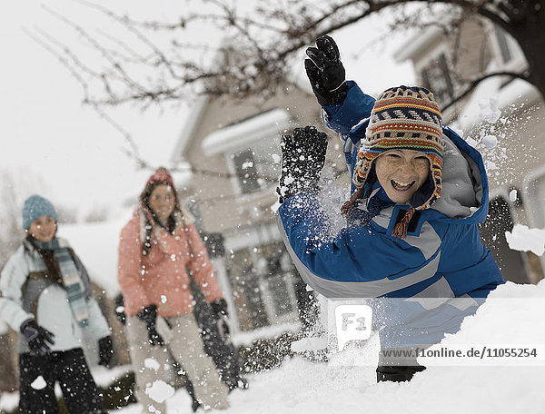 Winter snow. Three children having a snowball fight.