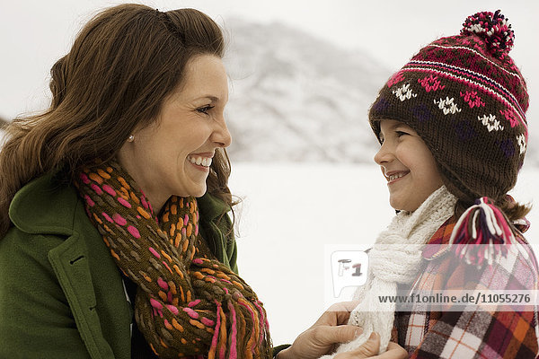 A woman and a young child in the snowy mountains.