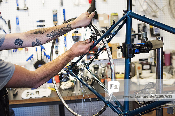 A man working in a bicycle repair shop.